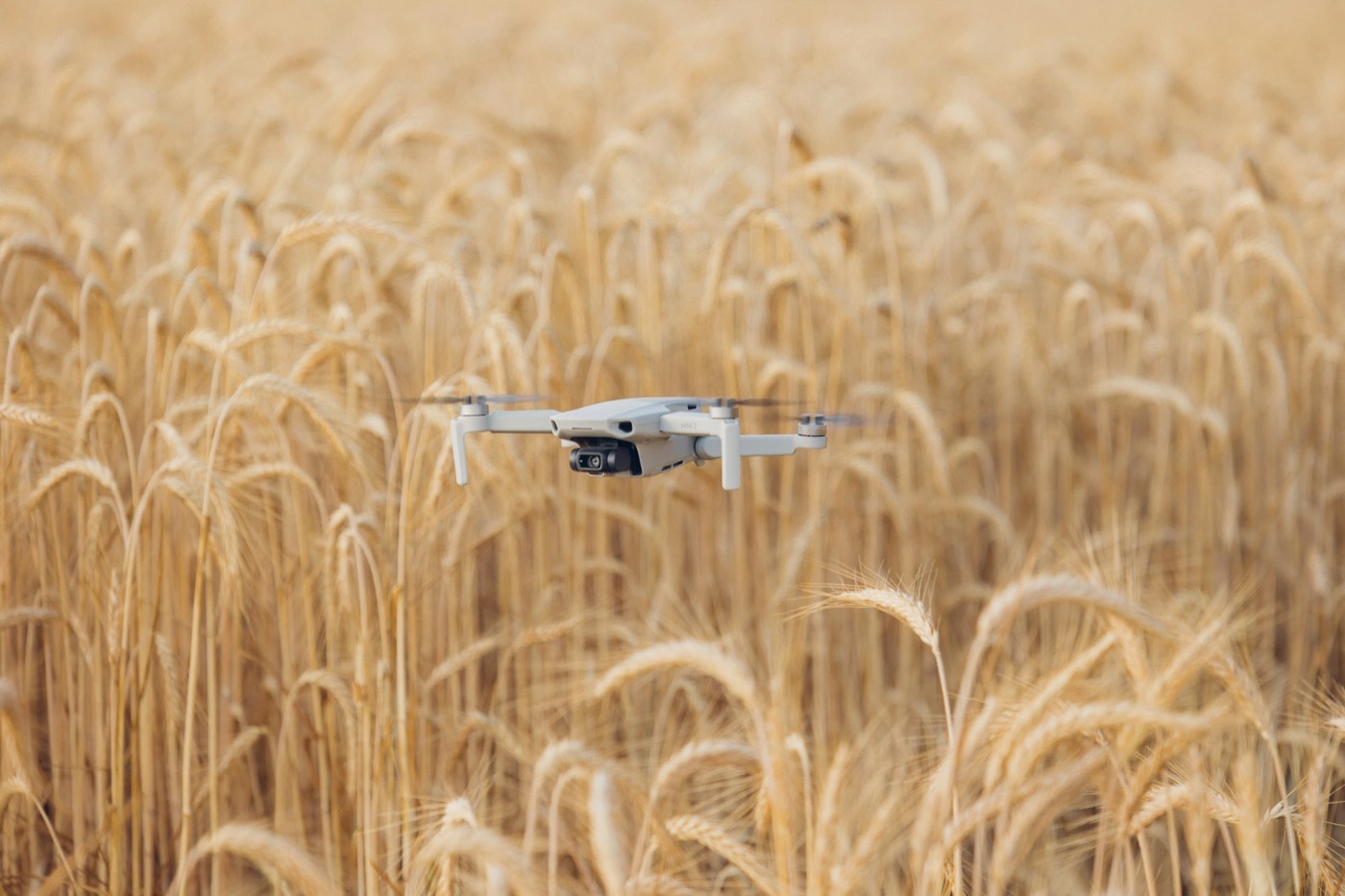 A survey drone flying low over an arable field